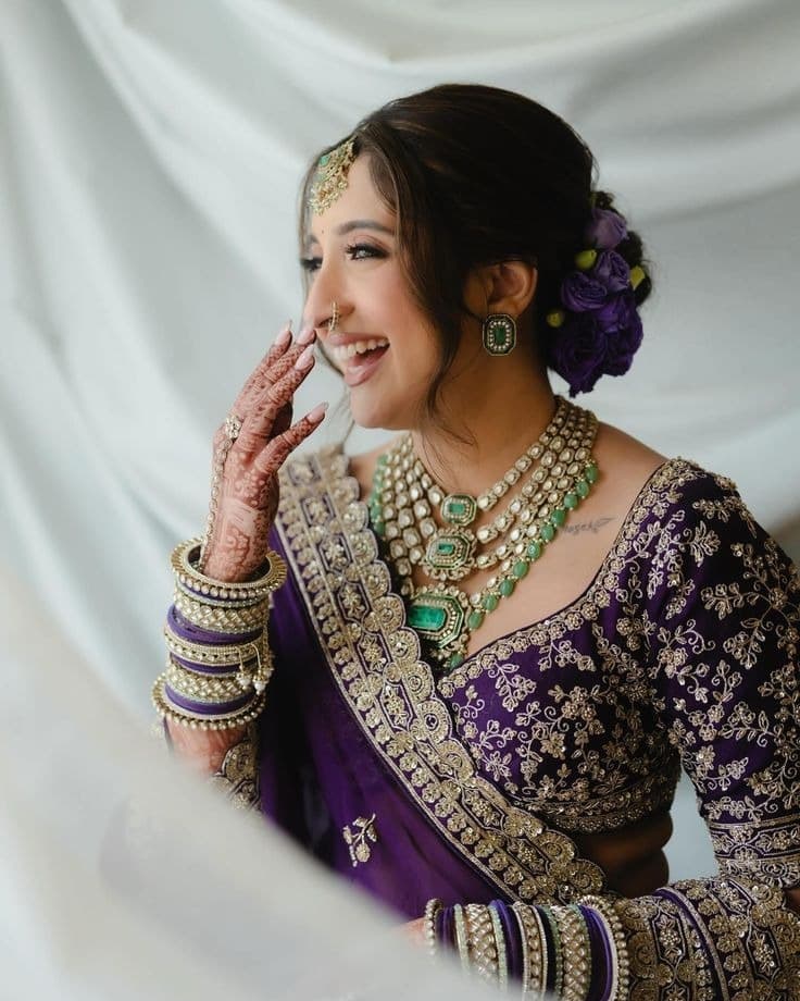 Bride wearing a layered emerald and sterling silver necklace, matching earrings, and stacked bangles from the AG Elements Bridal Collection
